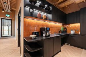 a kitchen with black cabinets and a counter top at Apex Executive Apartments - The Ironworks in Dublin