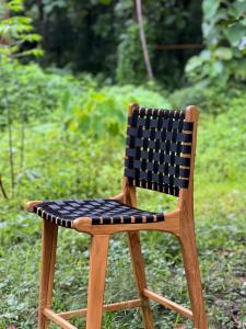a wooden chair with a black and white checkered seat at Adams Villas in Katiet