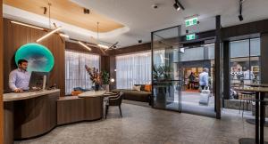 a man standing at a counter in a lobby at The Howey in Melbourne