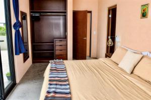a bedroom with a large bed and a closet at Simple Stay, Big Views, Private Room & Pool in Todos Santos