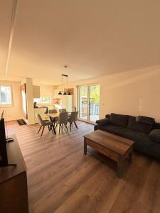 a living room with a couch and a table at Pollross Apartments in Reichenau