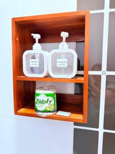 a wooden shelf with some food items on it at Elephant Hotel Luang Parabang in Luang Prabang