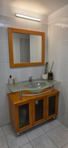 a bathroom with a sink and a mirror at Fare Iki in Papeete +5 photos