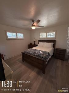 a bedroom with a bed and a ceiling fan at Casa Blanca in Irving