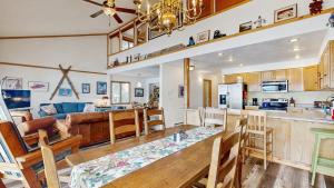 a kitchen and living room with a table and chairs at Lakeside Getaway Beach Access Shared Pool and Grills in McCall