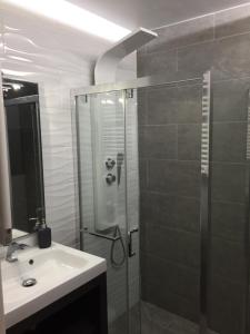 a bathroom with a glass shower and a sink at Studio proche pistes Chantemerle in Saint-Chaffrey