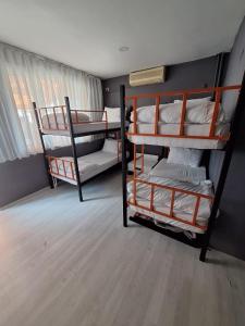 a room with three bunk beds in a room at Dilmac Hotel in Gelibolu