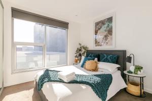 a bedroom with a bed and a large window at Lux 2BR Apt on Hindmarsh SQ-Pool-Gym-Parking in Adelaide +22 photos