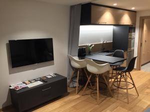 a kitchen with a table and chairs in a room at Studio proche pistes Chantemerle in Saint-Chaffrey