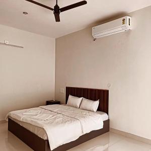 a bedroom with a bed with a ceiling fan at Myday Inn by Znormhomes in Varkala