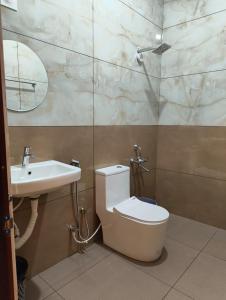 a bathroom with a toilet and a sink at Myday Inn by Znormhomes in Varkala
