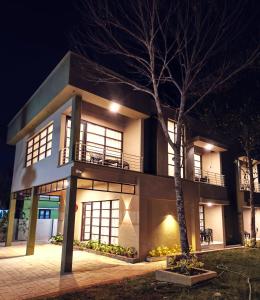 a house with a tree in front of it at night at Myday Inn by Znormhomes in Varkala