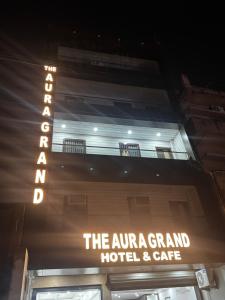 a sign for the entrance to a hotel and cafe at The Aura Grand Hotel and Cafe in Patna