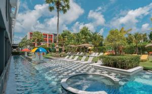 a swimming pool at a hotel with a resort at Sugar Marina Hotel - ART - Karon Beach in Karon Beach