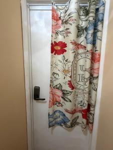 a door with a curtain with flowers on it at Citrus Loft - Quiet and convenient female only in Covina