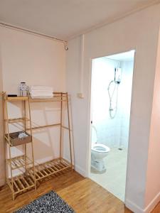 a bathroom with a toilet and a shower at Papa house red room in Pak Kret