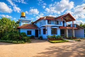 a house with a lighthouse on top of it at SugarLeaf Homestay - Home Food & Near to Tourist Places in Sakleshpur