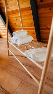 a towel rack with towels on a bunk bed at Peaceful Cabin in Lunca Bradului +61 photos