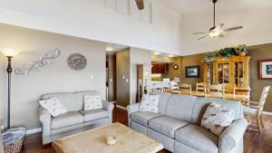 a living room with two couches and a dining room at Crystal Beach Condo - Lake Views & Pool in McCall