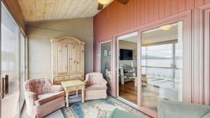 a living room with two chairs and a table at Crystal Beach Condo - Lake Views & Pool in McCall