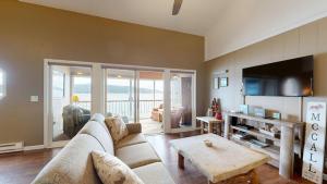 a living room with a couch and a table at Crystal Beach Condo - Lake Views & Pool in McCall