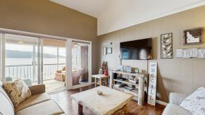 a living room with a couch and a table at Crystal Beach Condo - Lake Views & Pool in McCall +18 photos