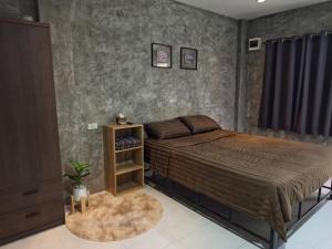a bedroom with a large bed with a brown blanket at 4Hearts Hotel in Suratthani +16 photos
