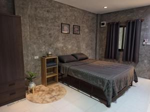 a bedroom with a bed and a nightstand and a bed sidx sidx sidx sidx at 4Hearts Hotel in Suratthani