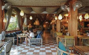 a woman sitting in a chair in a restaurant at Sugar Marina Hotel - FASHION - Kata Beach in Kata Beach
