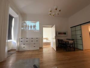 a living room with a bedroom and a dining room at City Center Apartment in Brno +1 photo