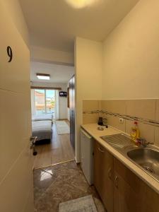 a kitchen with a sink and a bed in a room at Ajan Apartments in Ulcinj +123 photos
