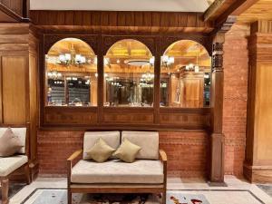 a room with a bench with two pillows on it at Hotel Dachi Kathmandu - Bhaktapur in Bhaktapur +51 photos