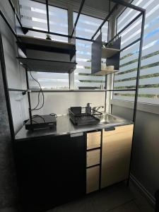 a kitchen with a counter with a sink and a window at LaMar in Skala Prinou