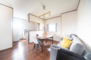 a living room with a couch and a table at Coucou! in Takasaki