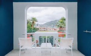 a room with a window with white chairs and a view at Sugar Marina Hotel - NAUTICAL - Kata Beach in Kata Beach +11 photos
