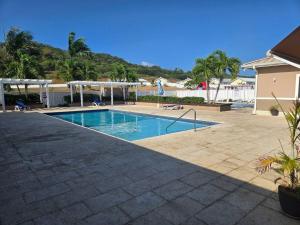 a swimming pool in a yard with a resort at The Cosy Home in Lucea
