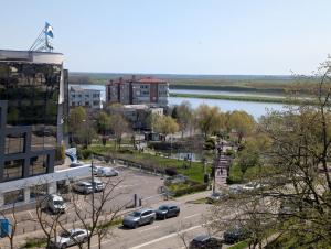 a city with cars parked in a parking lot next to a river at BGD Residence in Galaţi