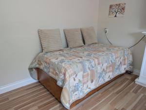 a bed with two pillows on it in a room at Modern, private & luxurious executive suite in Delta +32 photos