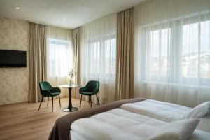 a bedroom with a bed and a table and chairs at Hotel Tatra in Bratislava +65 photos