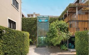 a glass building with a sign on it in a courtyard at Sugar Marina Hotel-SURF-Kata Beach in Kata Beach +17 photos