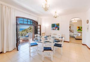 a dining room with a table and chairs at Villa Marecoco in Forio d'Ischia +45 photos