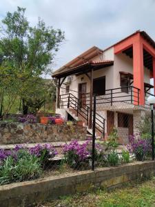 a house with purple flowers in front of it at Porto Κoufo Halkidiki in Porto Koufo