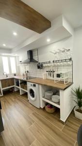 a kitchen with a sink and a washing machine at Carmen La Golondrina in Restábal