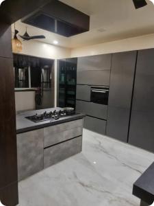a kitchen with stainless steel appliances and a marble floor at EVARA- Swaminarayan enclave in Nagpur