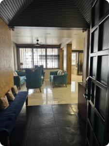a living room with blue couches and a tv at EVARA- Swaminarayan enclave in Nagpur
