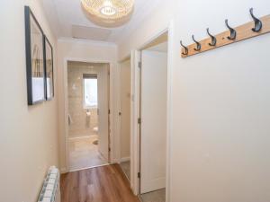 a hallway with a door to a bathroom with a mirror at Chestnut Timber Lodge in Keswick +85 photos