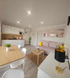 a living room with a couch and a table at Domki Wenta in Łeba