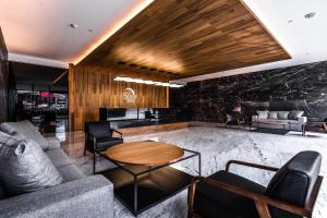 a lobby with couches and a table at Sleep Inn Ciudad de Mexico Cuajimalpa in Mexico City