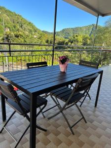 a blue picnic table with chairs and a vase of flowers at Ca' da Lisa in San Colombano Certenoli