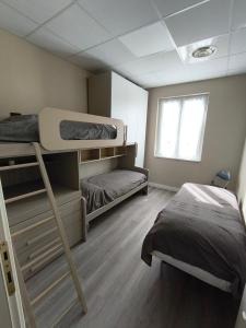 a bedroom with two bunk beds and a window at Ca' da Lisa in San Colombano Certenoli